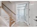 Bright entryway featuring wood stairs, white trim and an office with double glass doors at 905 Monmouth Dr., Myrtle Beach, SC 29588