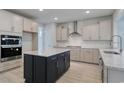 Modern kitchen boasts stainless appliances, light grey countertops, and a dark island at 905 Monmouth Dr., Myrtle Beach, SC 29588