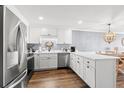 Updated kitchen featuring stainless steel appliances, wood floors, white cabinets and countertops, and recessed lighting at 917 S Ocean Blvd. # 103, Surfside Beach, SC 29575
