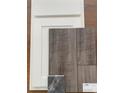 Close-up of interior design samples, featuring Shaw luxury vinyl flooring, cabinetry and granite sample at 977 Oak Hollow St., Longs, SC 29568