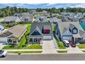 A high aerial shot showcases the beautiful neighborhood and the lovely home with manicured lawns at 1012 Mary Read Dr., North Myrtle Beach, SC 29582