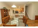 Dining room with a glass table and seating for six adjacent to kitchen at 1028 Fairway Ln. # 71, Conway, SC 29526