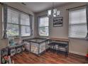 Bright dining area with hardwood floors, three windows, and modern chandelier at 1029 Tee Shot Dr. # 1029, Conway, SC 29526