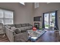 Spacious living room with hardwood floors, high ceilings, sliding glass door, and large gray couch at 1029 Tee Shot Dr. # 1029, Conway, SC 29526