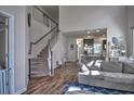 Open concept living space featuring a staircase, hardwood floors, and seamless flow to the kitchen at 1029 Tee Shot Dr. # 1029, Conway, SC 29526