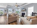 Bright living room with many windows, hardwood floors, fireplace, and comfortable seating creates a welcoming space at 104 Splendor Circle, Murrells Inlet, SC 29576