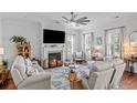 Cozy living room with fireplace, plush seating, large windows, and stylish decor at 1106 Tarpon Pond Rd., North Myrtle Beach, SC 29582