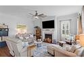 Bright living room featuring a fireplace, comfortable seating, and a ceiling fan for added comfort at 1106 Tarpon Pond Rd., North Myrtle Beach, SC 29582