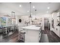 Bright kitchen with white cabinets, quartz countertops, a center island, and stainless steel appliances at 1114 Wigeon Dr., Conway, SC 29526