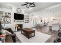 Spacious living room with fireplace, built-in shelving, ceiling fan, and hardwood floors at 1114 Wigeon Dr., Conway, SC 29526
