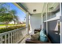 Inviting front porch with comfortable seating and views of the lush landscaping and neighborhood at 142 Grier Crossing Dr., Conway, SC 29526