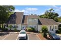 Well-kept exterior showing ample parking and charming curb appeal with tidy landscaping at 1422 Baldwin Ct. # 1422, Little River, SC 29566