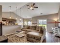 Open living area with vaulted ceilings, fan, hardwood floors, and a comfortable sectional sofa at 176 Springtide Dr., Conway, SC 29527