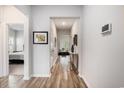 Bright hallway featuring wood floors, white walls, and an open view into the comfortable living room at 179 Empyrean Circle, Myrtle Beach, SC 29588