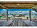 Relaxing outdoor patio featuring a hammock, picnic table, and lounge chairs with waterfront views at 1924 Pompano Dr., Garden City Beach, SC 29576