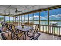 Inviting screened-in porch featuring an outdoor dining table with views of the water at 1924 Pompano Dr., Garden City Beach, SC 29576