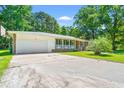 Well-maintained home featuring a brick exterior, attached garage, and a charming front porch area at 2415 Magnolia Lane, Little River, SC 29566