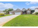 Charming brick house boasts a well-manicured lawn, mature trees, and an extended driveway at 2479 Glen Dr., Little River, SC 29566