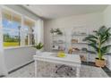 Bright office space featuring a large window, a white desk, and stylish shelving for an organized workspace at 2867 Riverboat Way, Conway, SC 29526