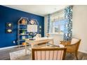 Home office with a stylish desk, blue accent wall, and lots of natural light at 292 Clear Lake Dr., Conway, SC 29526