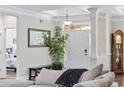Inviting foyer features elegant columns, a decorative mirror, a grandfather clock, and views into the living area at 310 Babylon Pine Dr., Myrtle Beach, SC 29579