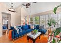 Bright living room featuring a vaulted ceiling, hardwood floors, and a comfortable seating area by large windows at 314 Lyons Cove Dr., Myrtle Beach, SC 29577