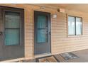 Exterior front door and entrance to unit with covered walkway and door mats at 3211 S Ocean Blvd. # 204, Myrtle Beach, SC 29577