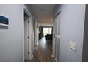 Hallway with wood-look flooring and closet space at 3401 Dunes St. # A3, North Myrtle Beach, SC 29582