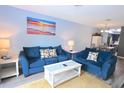 Bright living room offering beach artwork and comfortable blue sofas at 3401 Dunes St. # A3, North Myrtle Beach, SC 29582