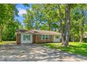 The exterior view displays an angle of the house showcasing its brick accents, siding, and the property's well-kept lawn at 4300 Crows Nest Ct., Myrtle Beach, SC 29579