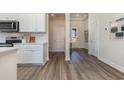 Bright entryway with a view of the front door and hall, connecting to a modern kitchen space at 444 Clear Lake Dr., Conway, SC 29526