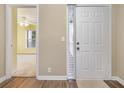 Inviting entryway showcasing wood floors, a white front door, and a glimpse into a bright, open living space at 4633 Lightkeepers Way # 5-F, Little River, SC 29566