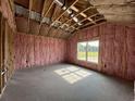 Bedroom under construction featuring a window, wood frame, insulation and concrete flooring at 475 Highway 348, Loris, SC 29569