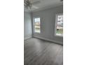Bright bedroom with water view, hardwood flooring, neutral paint, and ceiling fan at 4823 Riverside Dr., North Myrtle Beach, SC 29582