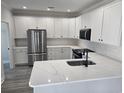 Bright, modern kitchen with white cabinets, stainless steel appliances, and quartz countertops at 4823 Riverside Dr., North Myrtle Beach, SC 29582