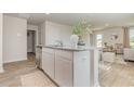 Modern kitchen featuring a granite island with breakfast bar, open to the living area at 7382 Meadow Walk Loop, Loris, SC 29569