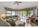 Comfortable living room with sliding glass doors to a patio and ceiling fan at 802 Colony Pl. # 2E, Calabash, NC 28468