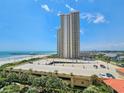 Wide view from a high-rise balcony, showcasing the beach, pier, parking and stunning ocean views at 8560 Queensway Blvd. # 508, Myrtle Beach, SC 29572