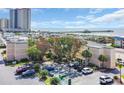 Exterior view of condo building with convenient parking, mature trees, and coastal charm at 9661 Shore Dr. # A1, Myrtle Beach, SC 29572