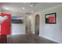 Bright, open-concept living area with modern flooring, fresh paint, and a vibrant red door for a pop of color at 1014 Bay Dr., Surfside Beach, SC 29575
