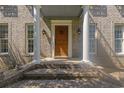 Close-up of the front porch with brick steps, white columns, and a welcoming wood door at 1140 Waterway Ln., Myrtle Beach, SC 29572