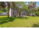Expansive front yard featuring lush green grass and mature trees surrounding a brick home at 1140 Waterway Ln., Myrtle Beach, SC 29572