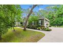 Charming one-story home with manicured landscaping, walkway, driveway, and attached garage surrounded by mature trees at 116 Chapel Ridge Circle, Myrtle Beach, SC 29588
