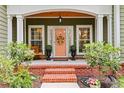 Inviting front porch with brick steps, decorative columns, bench, and a charming door with a seasonal wreath at 116 Chapel Ridge Circle, Myrtle Beach, SC 29588
