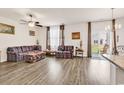 Inviting living room featuring hardwood flooring, two sofas, a ceiling fan and natural lighting at 1170 Maxwell Dr., Little River, SC 29566