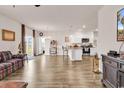 Open-concept living room showcasing hardwood flooring, stylish furnishings, and seamless access to the kitchen at 1170 Maxwell Dr., Little River, SC 29566