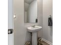 Compact powder room featuring a pedestal sink, a framed mirror, and neutral paint at 120 Carolina Lakes Blvd., Myrtle Beach, SC 29588