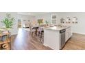 Open-concept kitchen with stainless steel appliances and granite countertops, seamlessly flowing into the living area at 1403 Nokota Dr., Conway, SC 29526