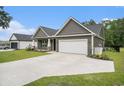 Well-kept one-story house with gray siding, a manicured lawn, and a spacious concrete driveway at 1476 Burriss Rd., Conway, SC 29526