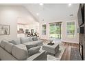Bright living room with vaulted ceiling, hardwood floors, brick fireplace, and access to the outdoors at 1476 Burriss Rd., Conway, SC 29526